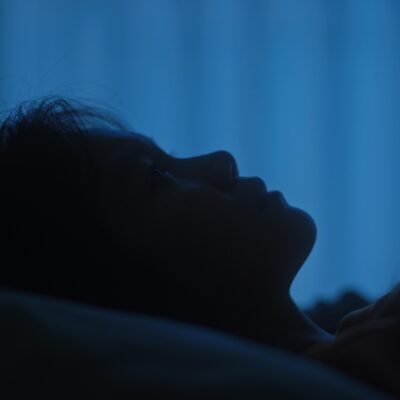 Person sleeping with digital health monitoring data overlay