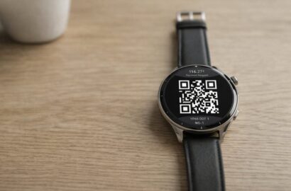 Smartwatch showing QR code for contactless payment via open banking